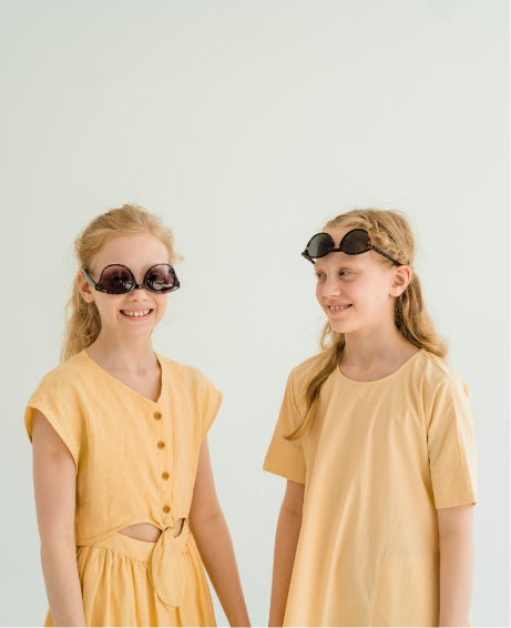  twin sisters goof off in yellow dresses 